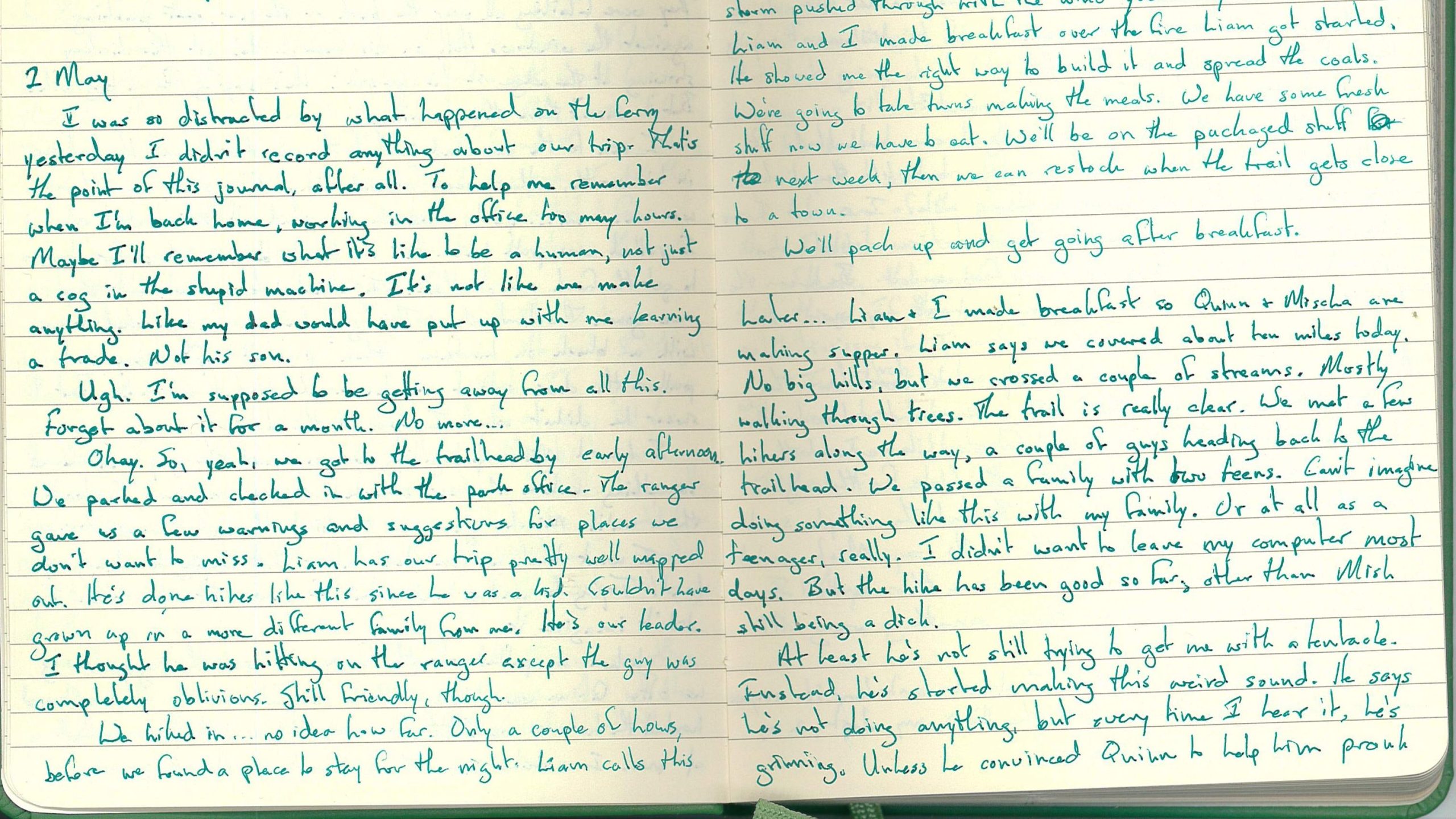 An open handwritten journal with green ink.